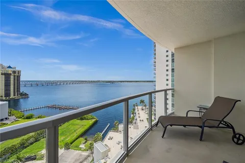 a view of a chairs and table in the balcony