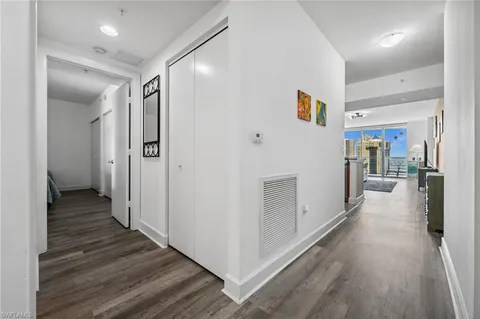 a view of a hallway with wooden floor