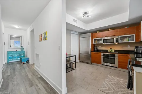 a kitchen with stainless steel appliances granite countertop a refrigerator and a stove top oven