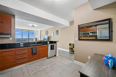 a large kitchen with stainless steel appliances granite countertop a sink and cabinets