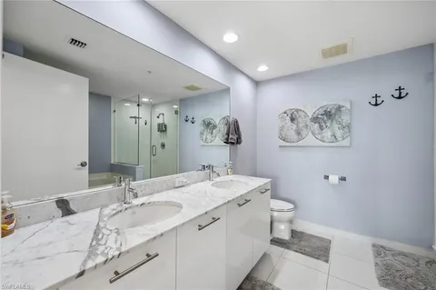 a spacious bathroom with a double vanity sink mirror and toilet