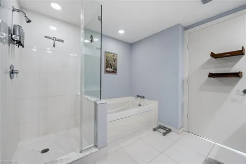 a bathroom with a shower a mirror and a shower