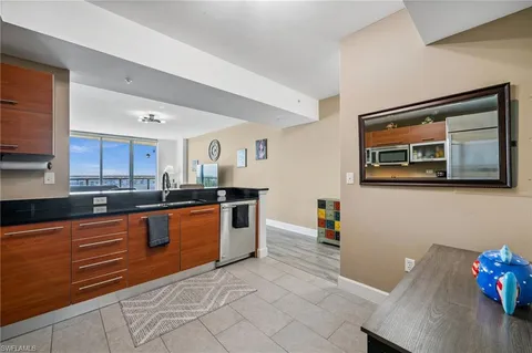 a large kitchen with stainless steel appliances granite countertop a sink and cabinets