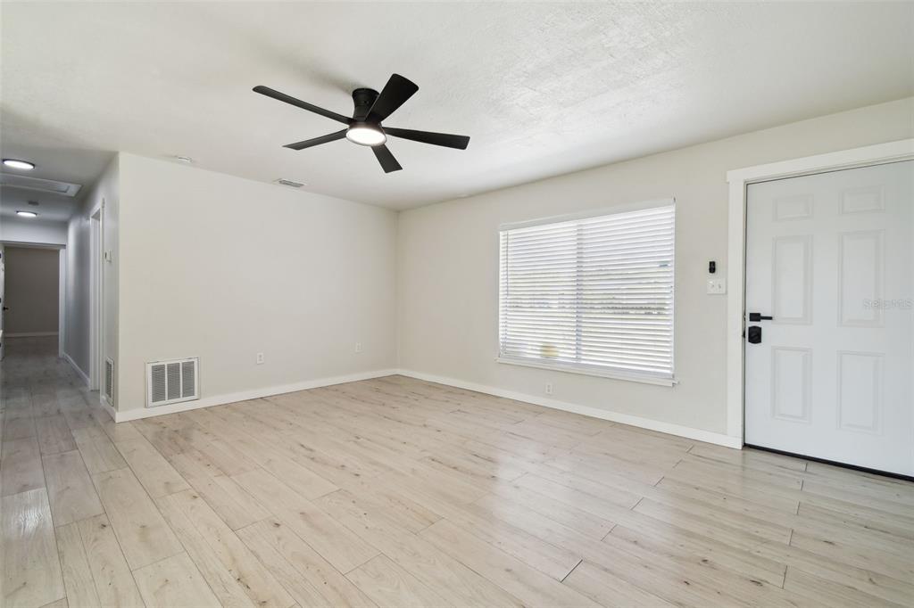 3414 Lindsey Street Dover, FL 33527 - Photo 12 of 45 a view of empty room with wooden floor and fan