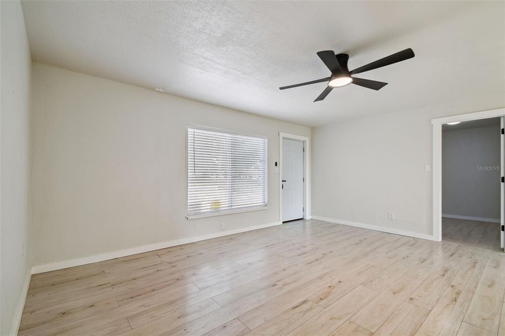 3414 Lindsey Street Dover, FL 33527 - Photo 13 of 45 a view of empty room with wooden floor and fan