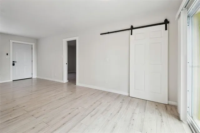 a kitchen with wooden floors and white cabinets