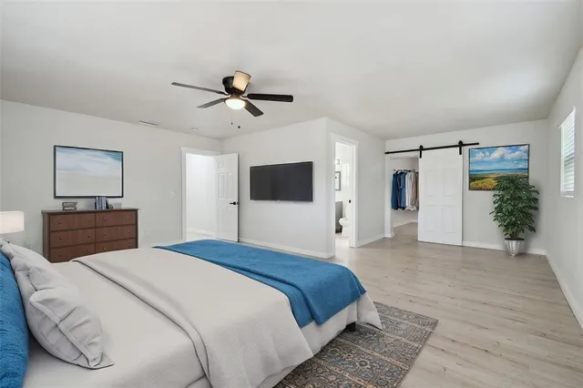 an empty room with wooden floor and a window