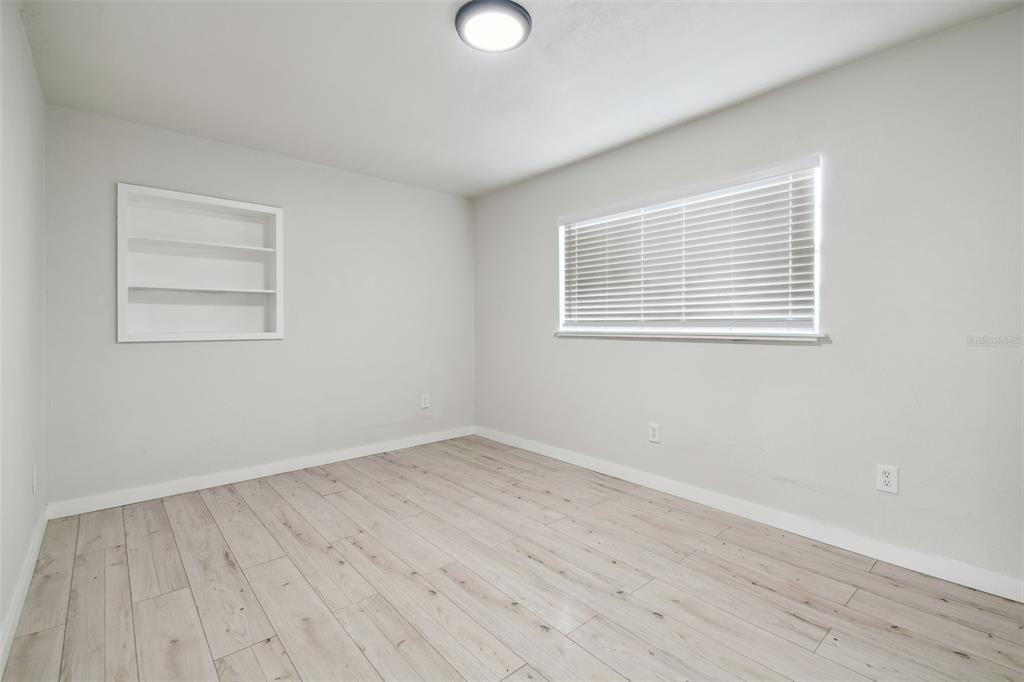 3414 Lindsey Street Dover, FL 33527 - Photo 31 of 45 an empty room with wooden floor and windows