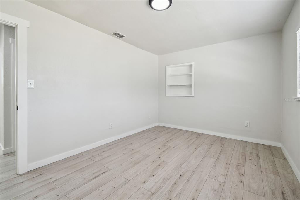 3414 Lindsey Street Dover, FL 33527 - Photo 32 of 45 an empty room with wooden floor and windows