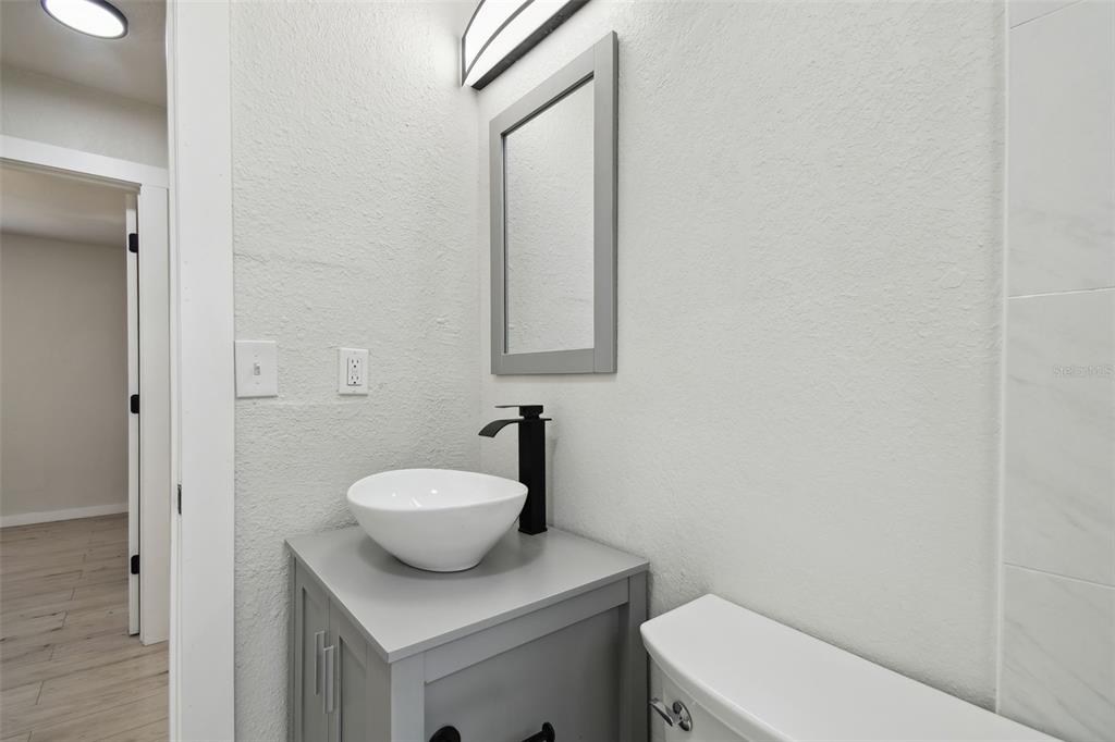 3414 Lindsey Street Dover, FL 33527 - Photo 42 of 45 a bathroom with a toilet sink and mirror