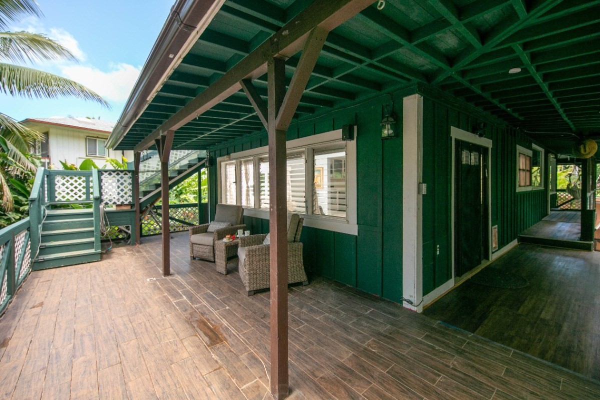 3590 Moloaa Road Kilauea, HI 96754 - Photo 17 of 22 a patio with table and chairs and potted plants with wooden floor
