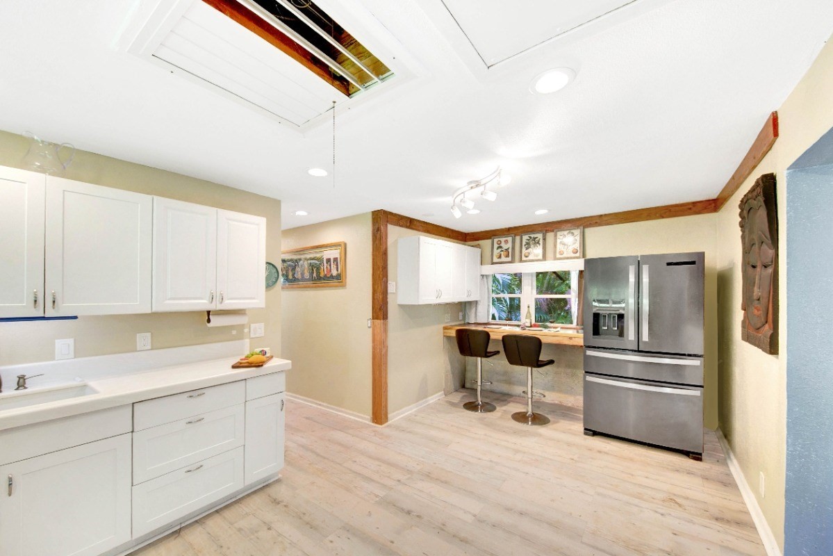 3590 Moloaa Road Kilauea, HI 96754 - Photo 4 of 22 a kitchen with stainless steel appliances kitchen island granite countertop a refrigerator and stove