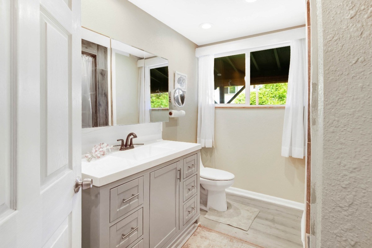 3590 Moloaa Road Kilauea, HI 96754 - Photo 7 of 22 a bathroom with a toilet sink and mirror