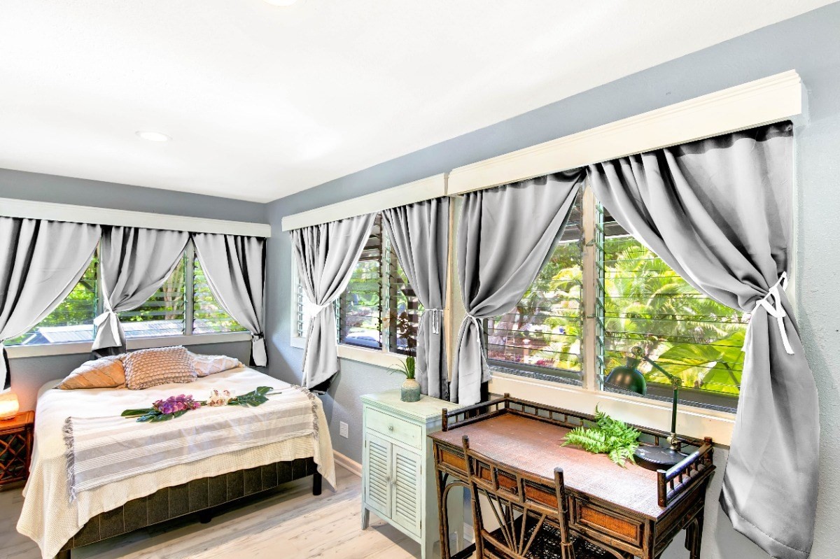 3590 Moloaa Road Kilauea, HI 96754 - Photo 9 of 22 a bedroom with a bed and a table