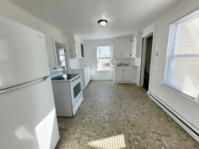 a kitchen with a sink a stove and refrigerator