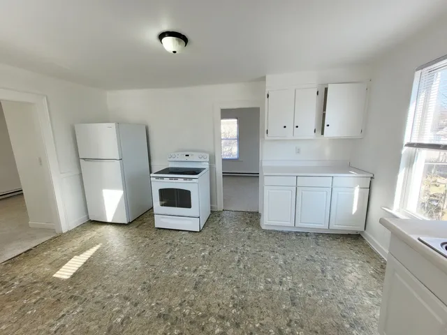 a room with a fireplace and a window