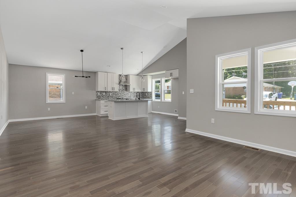 519 Barton Street Durham, NC 27707 - Photo 3 of 9 a view of kitchen with wooden floor and window