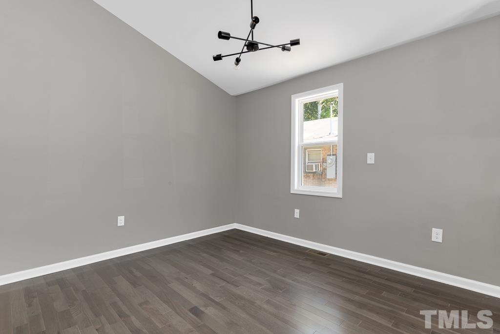 519 Barton Street Durham, NC 27707 - Photo 5 of 9 a view of a room with wooden floor and a ceiling fan