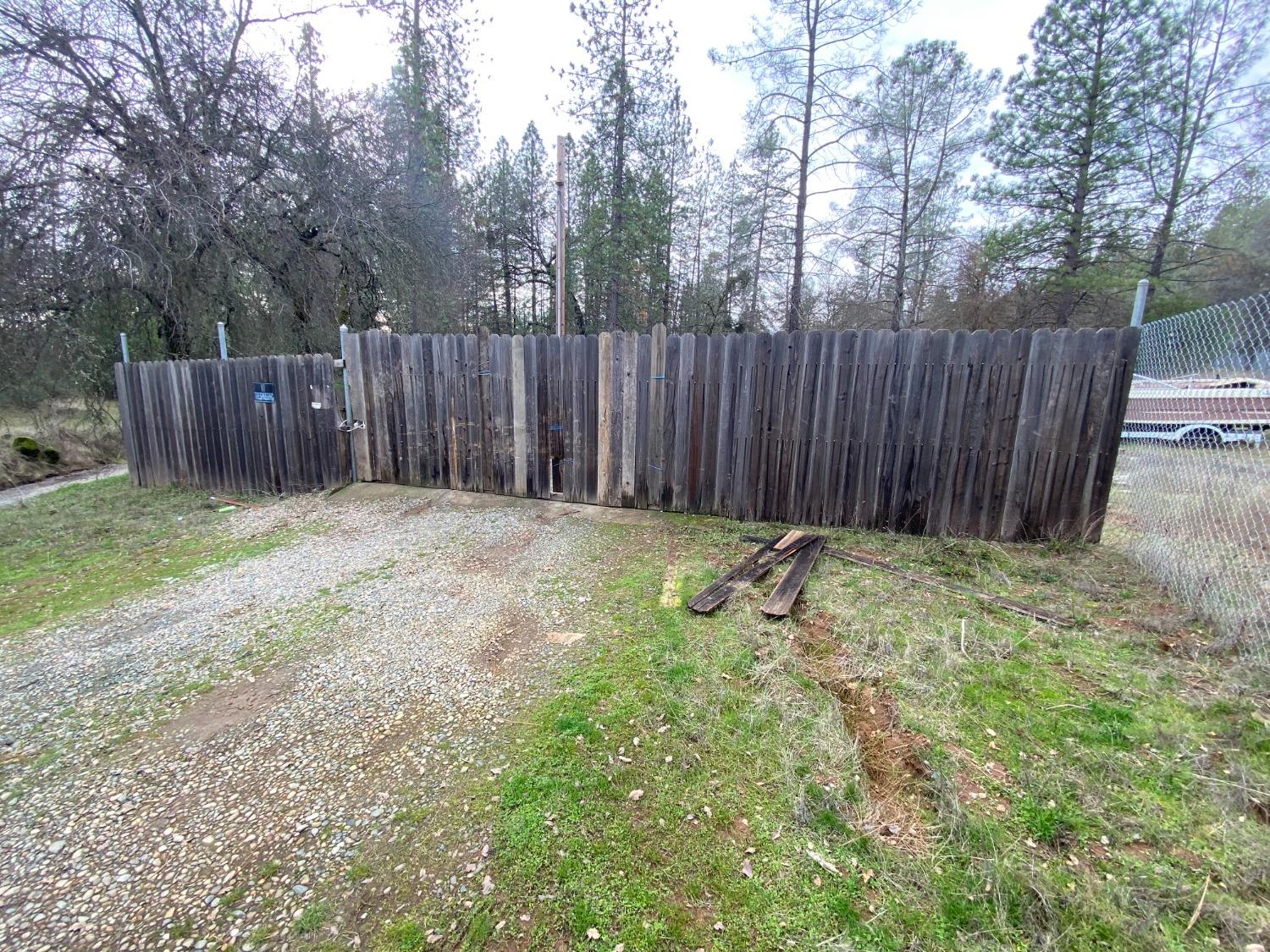 a view of small yard with wooden fence