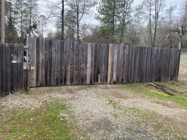 a view of outdoor space with wooden fence