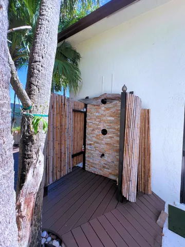 a view of a hardwood floor and potted plants