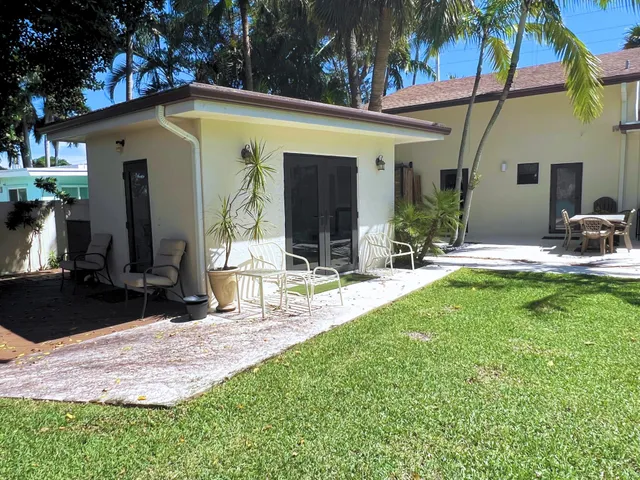 a front view of house with yard and outdoor seating