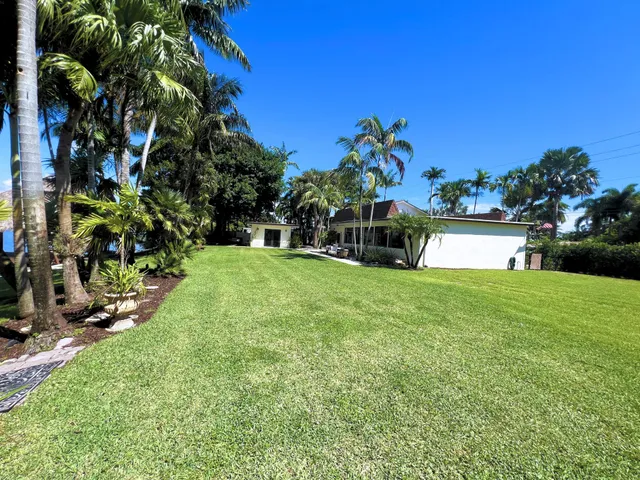 a view of a garden with a building in the background