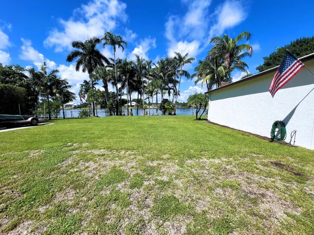 a view of a yard with a house in the background