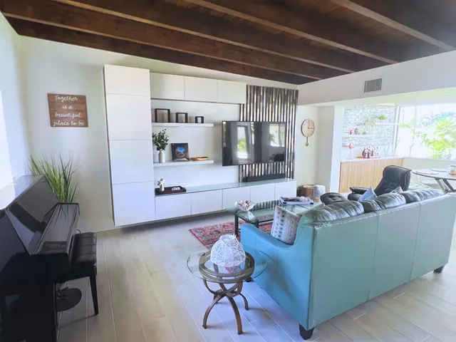 a living room with furniture and wooden floor
