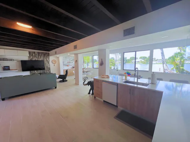 a large white kitchen with a large window