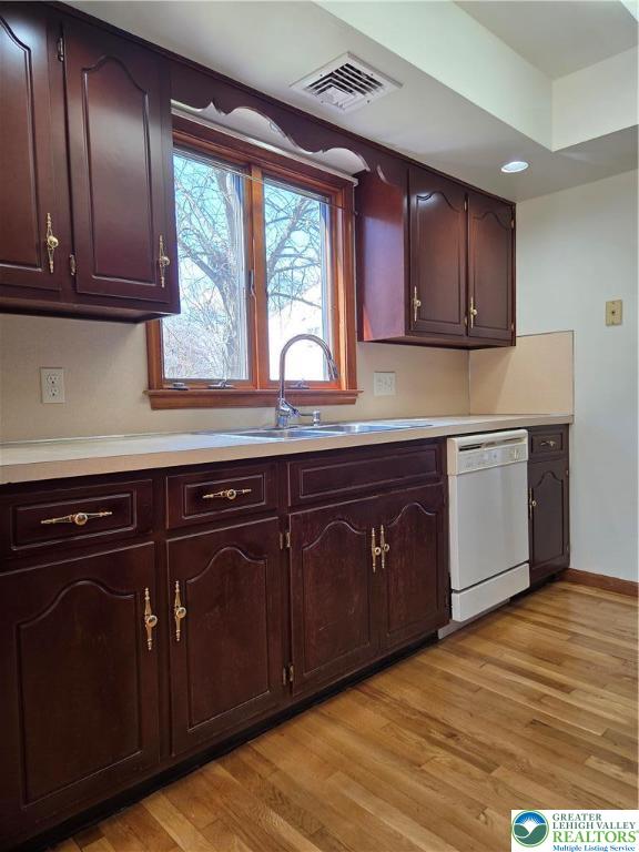 1728 Butztown Road, Unit C1 Bethlehem, PA 18017 - Photo 19 of 33 a kitchen with stainless steel appliances granite countertop wooden cabinets a sink and dishwasher with wooden floor