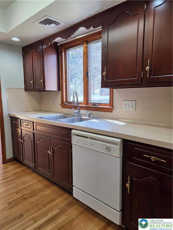 1728 Butztown Road, Unit C1 Bethlehem, PA 18017 - Photo 20 of 33 a kitchen with stainless steel appliances granite countertop wooden cabinets a sink and dishwasher with wooden floor