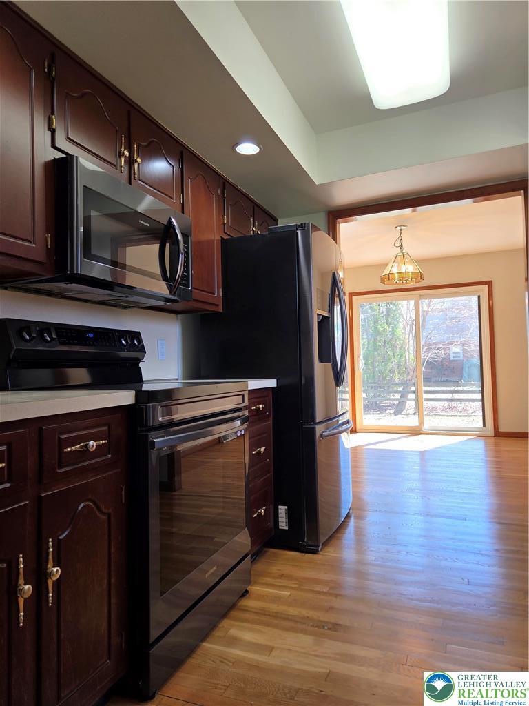 1728 Butztown Road, Unit C1 Bethlehem, PA 18017 - Photo 21 of 33 a kitchen with stainless steel appliances granite countertop a stove a refrigerator and a microwave oven