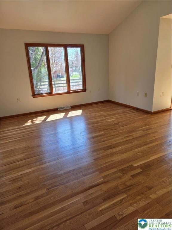 1728 Butztown Road, Unit C1 Bethlehem, PA 18017 - Photo 26 of 33 a view of an empty room with wooden floor and a window