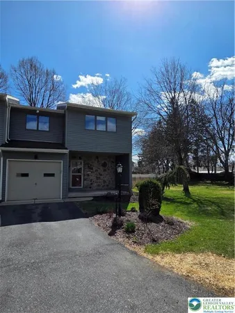 a view of a house with a yard and garage
