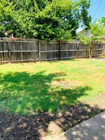 a view of a backyard with a small swimming pool