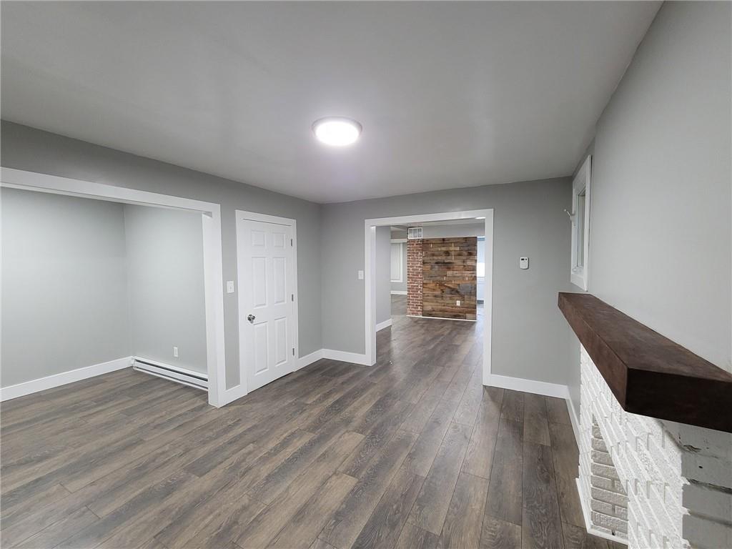 313 Mercer Street Butler, PA 16001 - Photo 2 of 12 a view of an empty room with wooden floor and a window