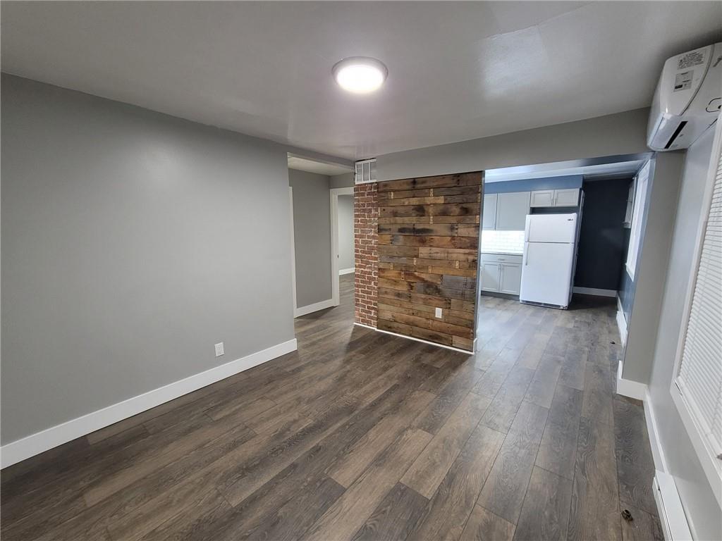 313 Mercer Street Butler, PA 16001 - Photo 4 of 12 a view of empty room with wooden floor
