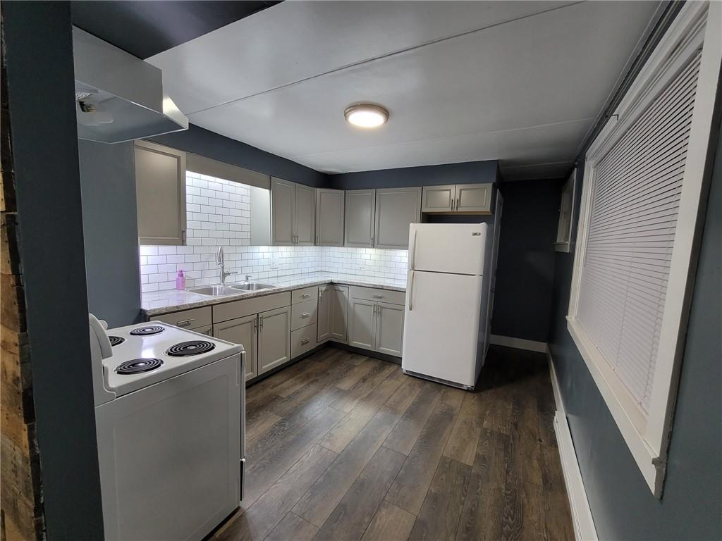 313 Mercer Street Butler, PA 16001 - Photo 5 of 12 a kitchen with a refrigerator a sink and white cabinets