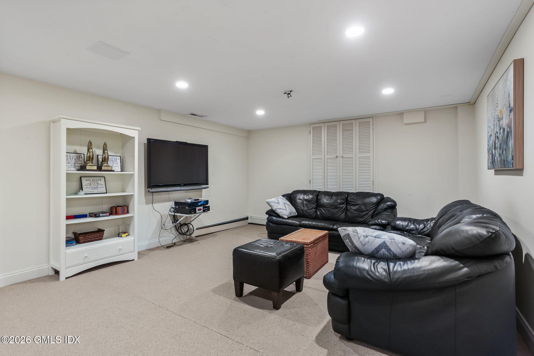 153 Lockwood Road Riverside, CT 06878 - Photo 41 of 58 a living room with furniture and a flat screen tv