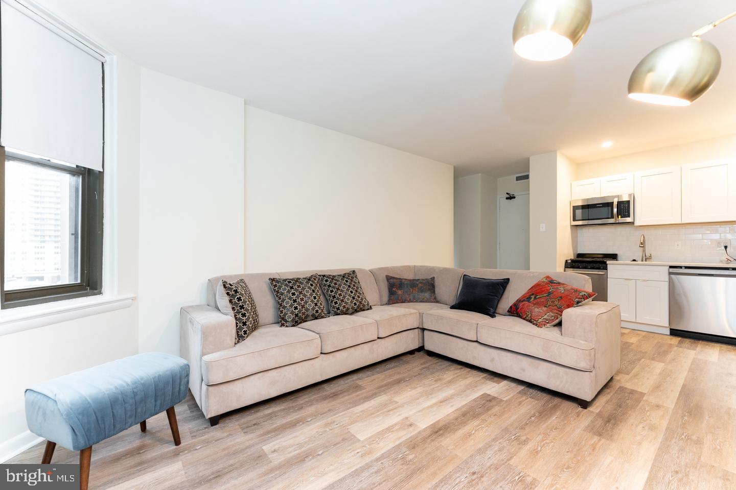 135 South 19th Street, Unit 707 Philadelphia, PA 19103 - Photo 2 of 14 a living room with furniture and a couch