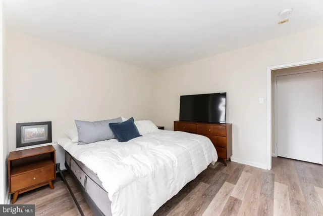 a bedroom with a bed and a night stand