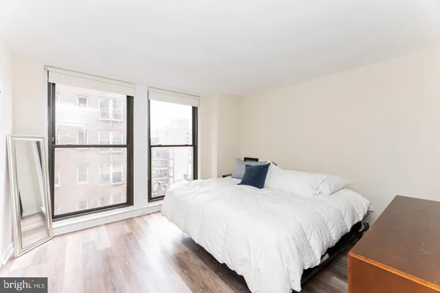 a bedroom with a large bed and a large window