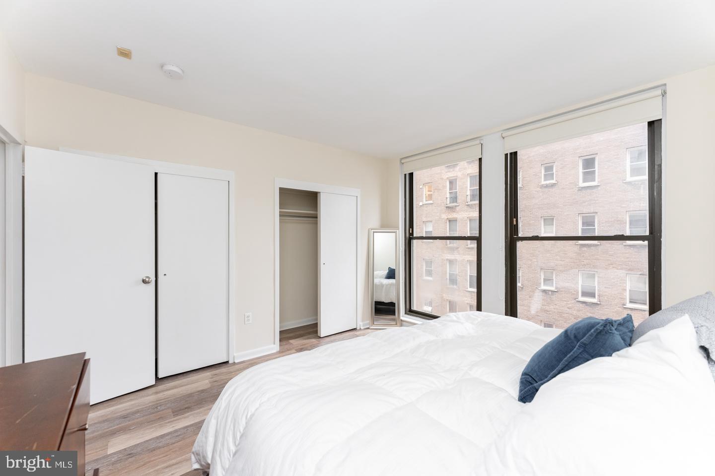135 South 19th Street, Unit 707 Philadelphia, PA 19103 - Photo 7 of 14 a bedroom with a bed and a large window