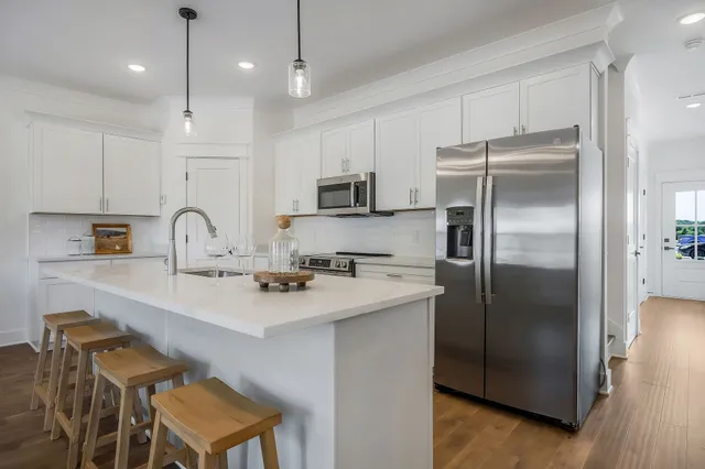 a kitchen with stainless steel appliances a refrigerator sink and microwave