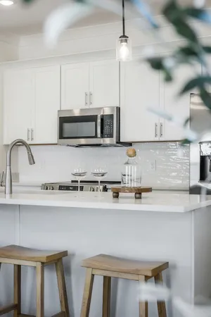 a kitchen with stainless steel appliances a sink a stove a microwave and wooden cabinets