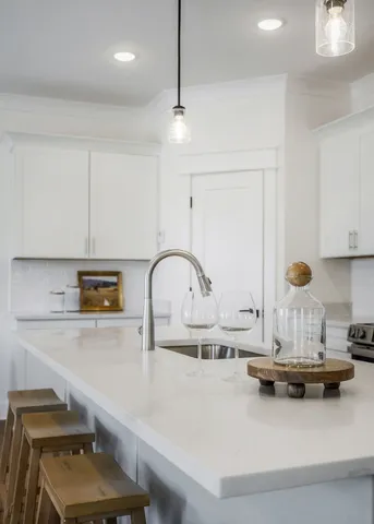 a kitchen with kitchen island a sink appliances and cabinets