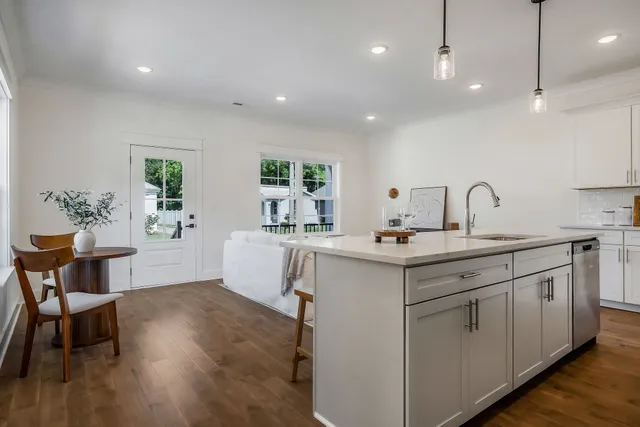 a kitchen with a sink cabinets and wooden floor