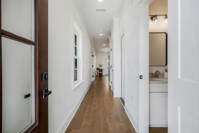 a view of a hallway with a wooden floor
