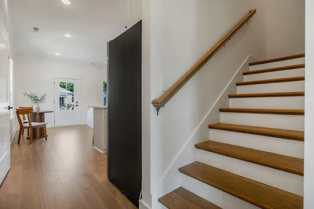 a view of entryway and hall with wooden floor